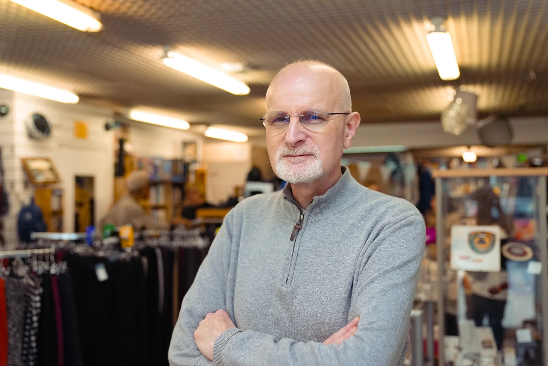 A local shop owner standing in his store